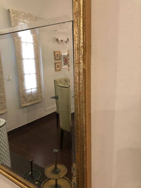 golden brass mirror and beige and golden cushioned seats 5