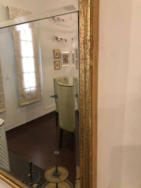 golden brass mirror and beige and golden cushioned seats 6