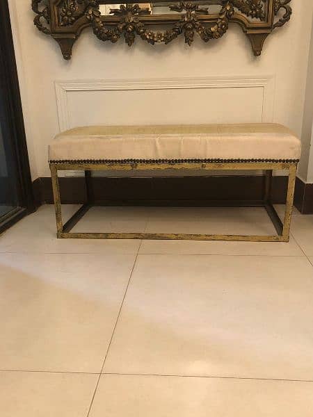 golden brass mirror and beige and golden cushioned seats 10