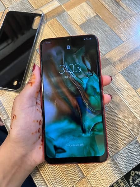 Samsung A10 phone in red color. 0