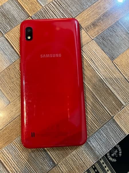 Samsung A10 phone in red color. 2