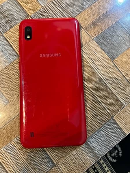 Samsung A10 phone in red color. 3