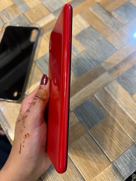 Samsung A10 phone in red color. 4