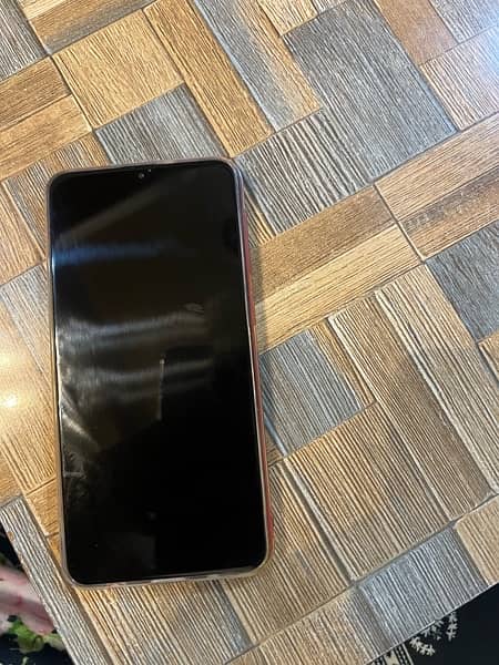 Samsung A10 phone in red color. 5