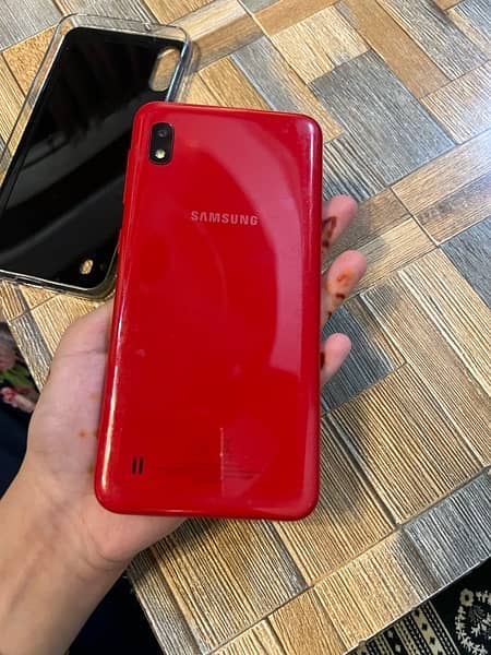 Samsung A10 phone in red color. 9