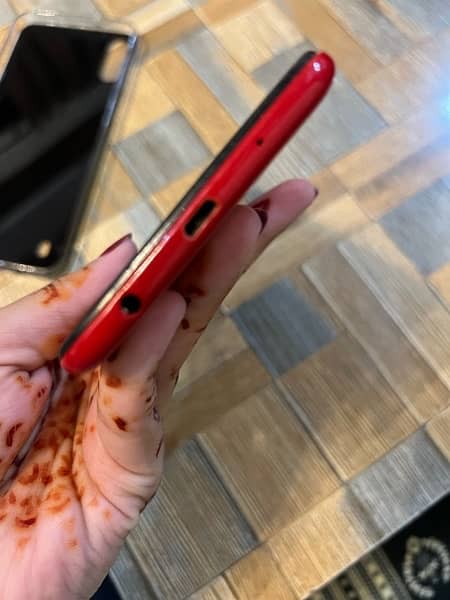 Samsung A10 phone in red color. 11