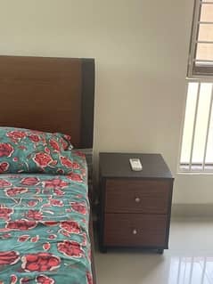 single bed with one side table and mattress