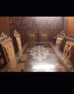 wooden made dinning table with 8 crowned chairs