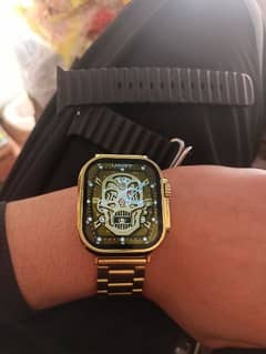 golden watch with black extra straps