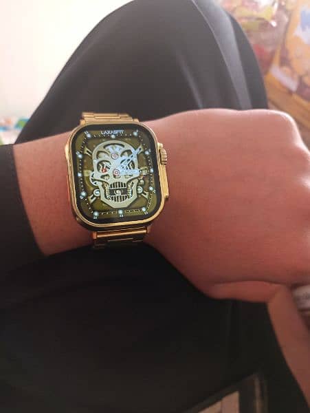 golden watch with black extra straps 4