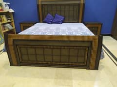 Wooden queen sized double bed with two side tables