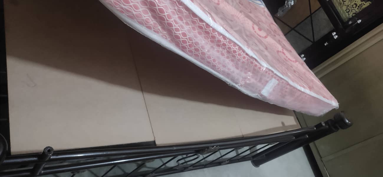 Iron bed with brand new mattress. 0