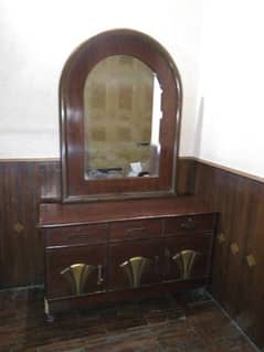 wooden bed and dressing table