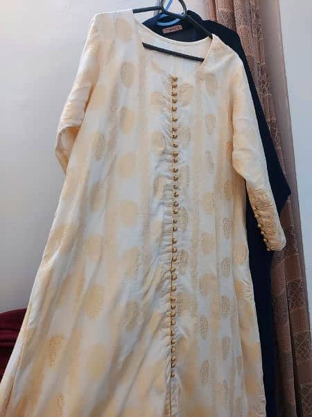 one pcs jacarad A line frock in off white colour with attached slip . 1