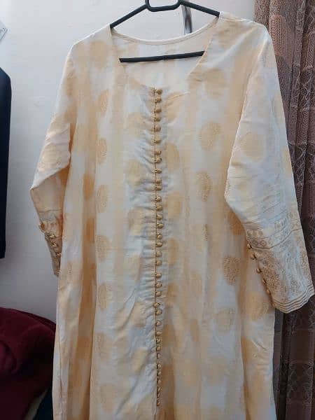 one pcs jacarad A line frock in off white colour with attached slip . 2