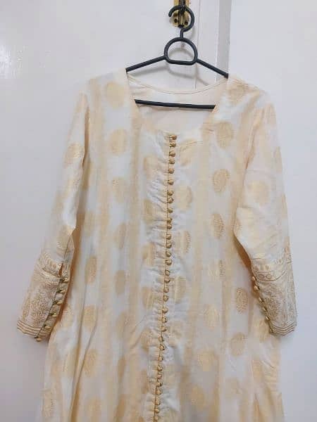 one pcs jacarad A line frock in off white colour with attached slip . 5