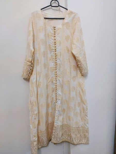 one pcs jacarad A line frock in off white colour with attached slip . 6