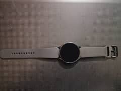 Samsung Galaxy Watch 4 with original charging cable and box.