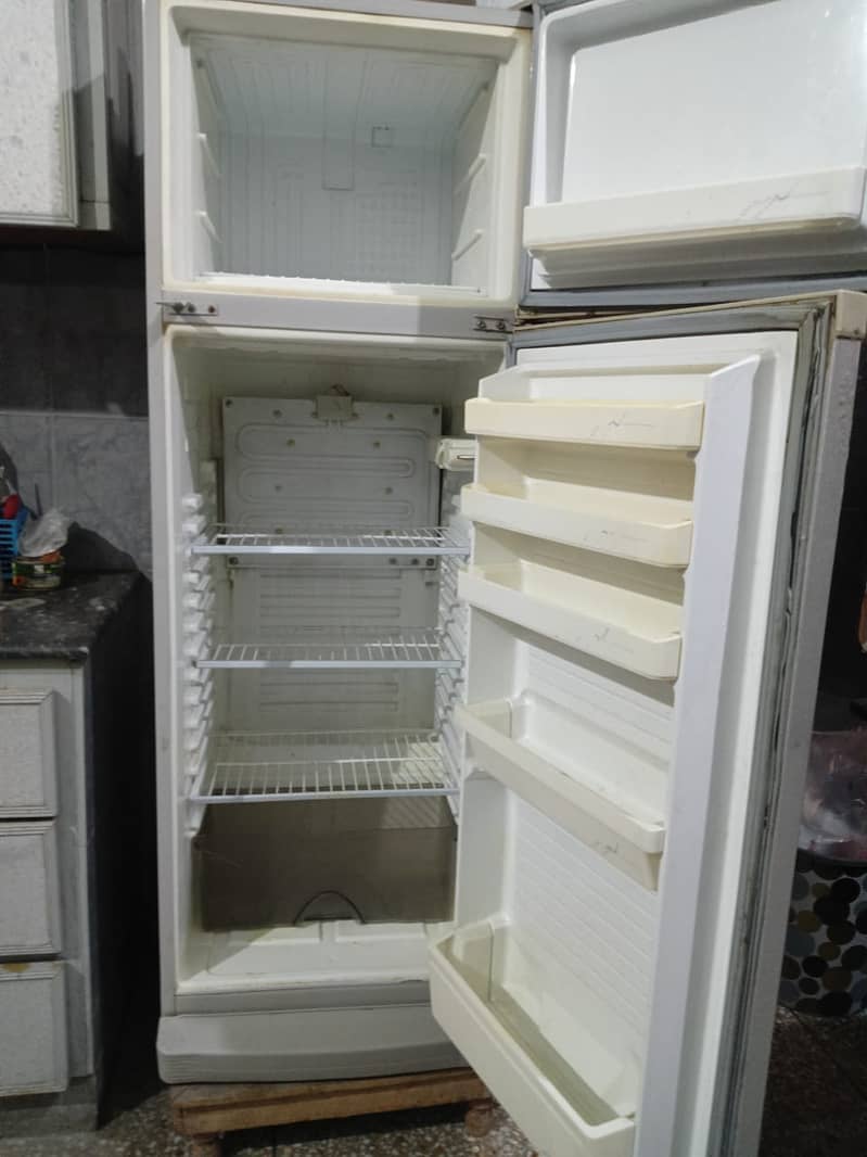 "Stay cool and comfortable! Dawnlance refrigerator with wooden stool. " 0