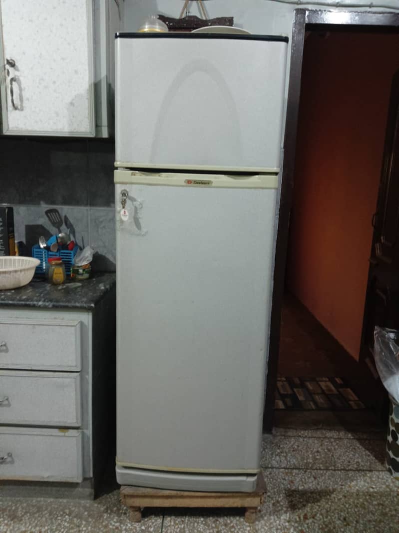 "Stay cool and comfortable! Dawnlance refrigerator with wooden stool. " 1