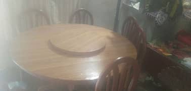 A dinning table with five chairs 0