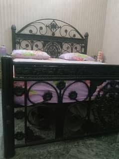 iron bed with mattress and side tables