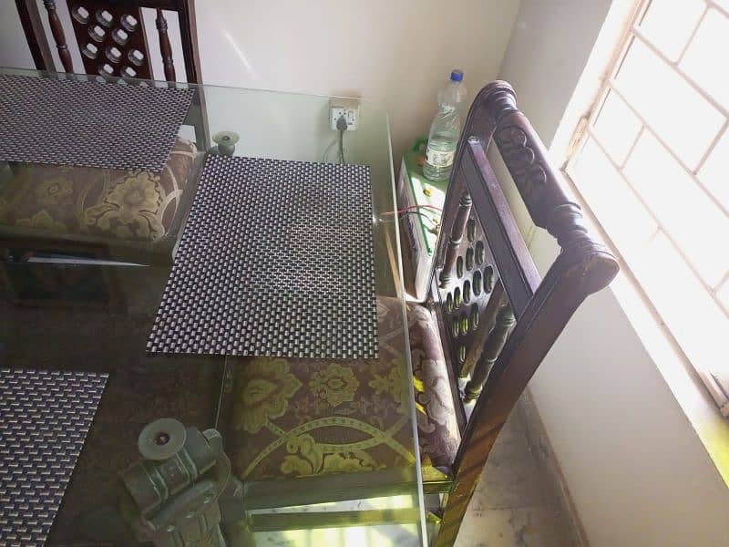 six seater dining table with glass top in very good condition 0