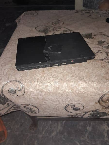 play station 2 with CDs,controller,memory card and wires 0