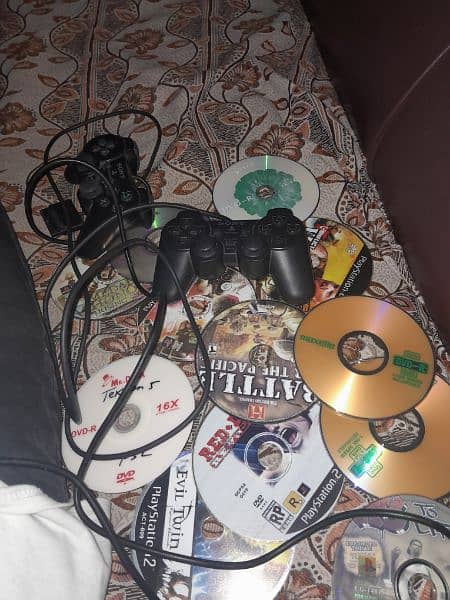 play station 2 with CDs,controller,memory card and wires 1