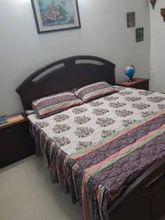 Double bed with mattress and side table