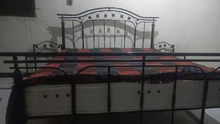 king side bed without mattress. along with side tables.