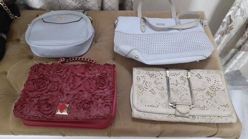 mixed variety of used bags for sale . 3