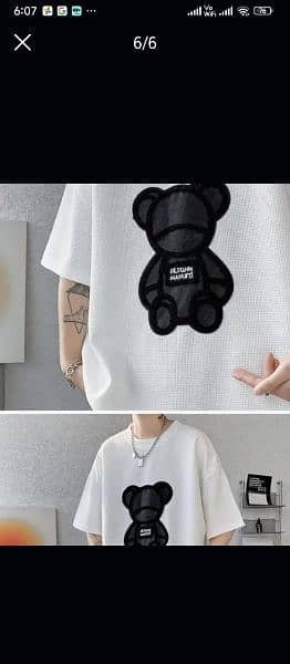 Man and woman over size drop shoulder t-shirt branded fluffy bell. 5