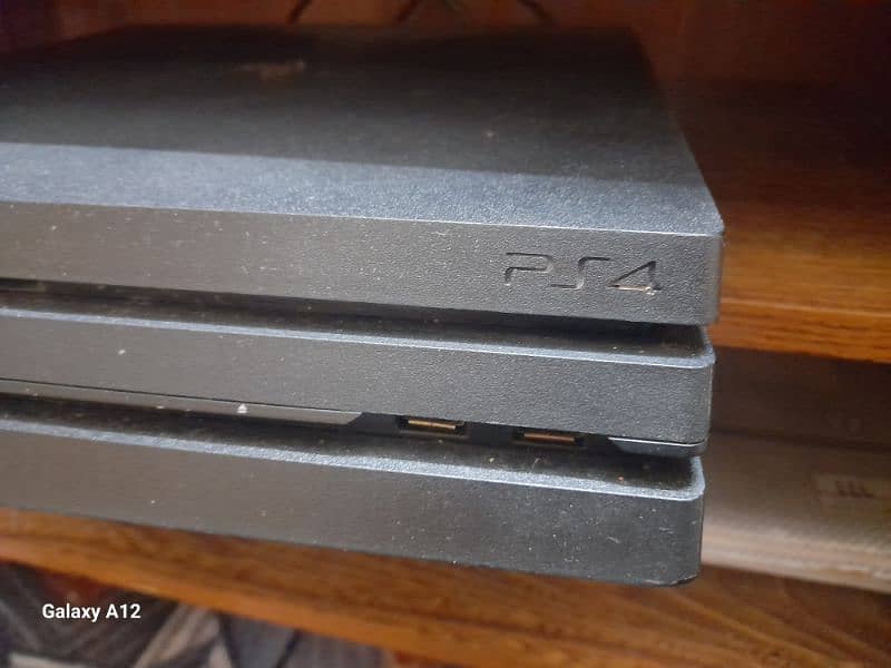 PS4 pro with two high-quality remotes and 5 video games 9