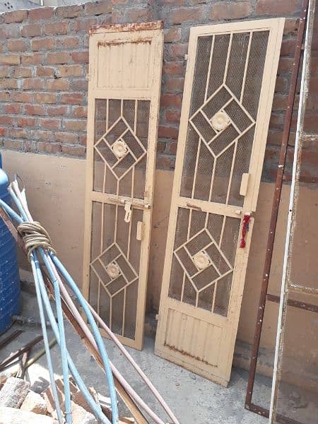 3 used windows one grilled door and iron frame and net 0