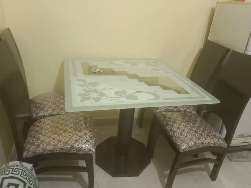 Selling Wooden Dining Table with Glass top and 4 chairs . . . conditio 0