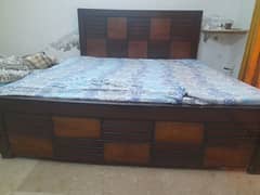 wooden bed with mattress
