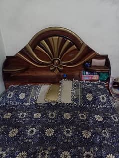 wooden bed with mattress and sofa