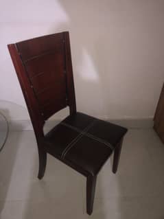 4 brown wooden chairs with cushion seats