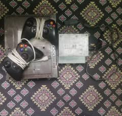 Xbox 360 with 2 controllers, games, and power supply