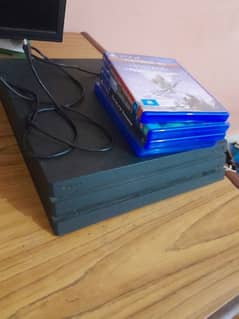 PS4 PRO 1TB WITH 4 GAMES AND ORIGNAL ACCESSORIES