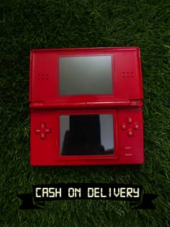 Red Nintendo DS Lite with charger, games including Mario and Pokemon.