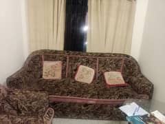 Brown colour sofa set with maroon cushions