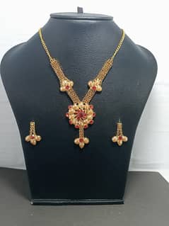 Beautiful Golden Necklace Set with Red colour Stones For Ladies