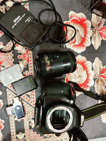 Nikon D5200 with a lens + 2 battries +charger and a sd card 0