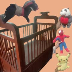 WOODEN BABY COT WITH GIANT BLACK AND RED HORSE AND 3 TEDDY BEARS