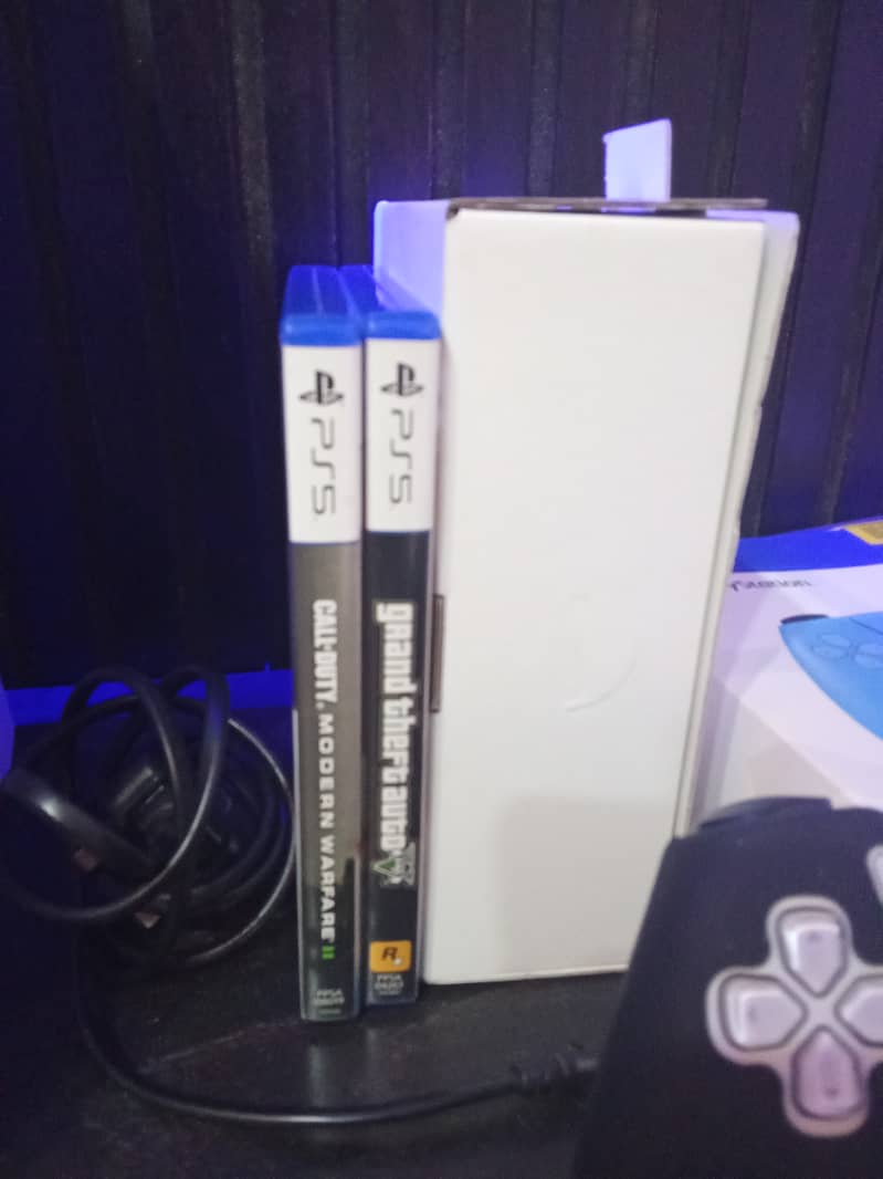 PS5 with two controllers and 2 games 1