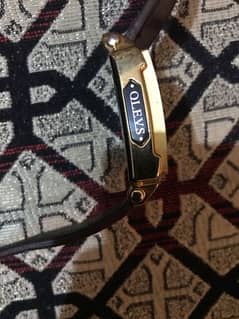 watch name” OLEVS “ 10% by 9%, Golden colour , blown belt