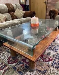 6 seater brown sofa set along with a glass table