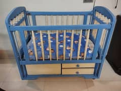 Blue and off white wooden baby cot